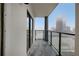 Balcony with glass railing and view of city buildings in the distance at 1280 W Peachtree Nw St # 3009, Atlanta, GA 30309