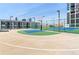 A basketball court is pictured next to a high rise building and tennis courts at 1280 W Peachtree Nw St # 3009, Atlanta, GA 30309