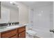 Bathroom features a granite vanity, white toilet and shower over tub combination at 1280 W Peachtree Nw St # 3009, Atlanta, GA 30309