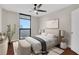 This staged bedroom is spacious and features a ceiling fan, lots of light, and elegant decor at 1280 W Peachtree Nw St # 3009, Atlanta, GA 30309