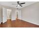 Bedroom with hardwood floors showing doorways to bathroom and another room with a refrigerator at 1280 W Peachtree Nw St # 3009, Atlanta, GA 30309