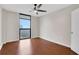 Bright bedroom featuring a ceiling fan, window with blinds and hardwood flooring at 1280 W Peachtree Nw St # 3009, Atlanta, GA 30309