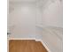 Walk-in closet features hardwood floors and wire shelving at 1280 W Peachtree Nw St # 3009, Atlanta, GA 30309