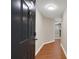 Entryway featuring wood floors, a modern ceiling light and a dark painted front door at 1280 W Peachtree Nw St # 3009, Atlanta, GA 30309