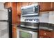 Well-equipped kitchen with stainless steel appliances, dark wood cabinets, and ample counter space at 1280 W Peachtree Nw St # 3009, Atlanta, GA 30309