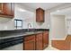 Functional kitchen featuring dark wood cabinets, stainless steel appliances, and a view into the living area at 1280 W Peachtree Nw St # 3009, Atlanta, GA 30309