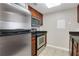 Kitchen features stainless steel oven and refrigerator, granite countertops, and wood cabinetry at 1280 W Peachtree Nw St # 3009, Atlanta, GA 30309