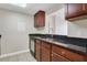 Well-lit kitchen with granite countertops, wooden cabinets, and stainless steel dishwasher at 1280 W Peachtree Nw St # 3009, Atlanta, GA 30309