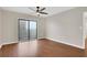 An empty bedroom features hardwood floors, a ceiling fan, and sliding glass door at 1280 W Peachtree Nw St # 3009, Atlanta, GA 30309