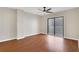 Empty bedroom with hardwood floors, ceiling fan, and a sliding glass door to the outside at 1280 W Peachtree Nw St # 3009, Atlanta, GA 30309