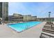 Large outdoor swimming pool with clear blue water and lounge chairs for residents at 1280 W Peachtree Nw St # 3009, Atlanta, GA 30309