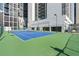 Community tennis court with a blue surface, surrounded by a green fence at 1280 W Peachtree Nw St # 3009, Atlanta, GA 30309