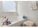 Relaxing bathroom featuring a large bathtub and window at 6292 Hickory Lane Cir, Union City, GA 30291