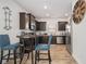 Modern kitchen with dark cabinets, stainless steel appliances, and wood-look floors at 6292 Hickory Lane Cir, Union City, GA 30291