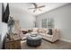 Spacious living room with sectional sofa, ottoman, and large TV at 6292 Hickory Lane Cir, Union City, GA 30291