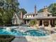 Luxury home featuring backyard pool, outdoor fireplace, and lush landscaping at 4345 Mount Paran Nw Pkwy, Atlanta, GA 30327