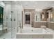 Luxurious bathroom featuring a separate shower and soaking tub, elegant fixtures, and a walk-in closet at 4345 Mount Paran Nw Pkwy, Atlanta, GA 30327