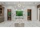 Elegant bathroom with marble floors, soaking tub, separate shower, and a picturesque window overlooking lush greenery at 4345 Mount Paran Nw Pkwy, Atlanta, GA 30327