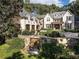 Luxury residence showcases professionally landscaped grounds, stone accents, water feature, and three-car garage at 4345 Mount Paran Nw Pkwy, Atlanta, GA 30327