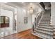 Elegant foyer features a staircase with patterned carpet, wood floors, and a view to the front door at 4345 Mount Paran Nw Pkwy, Atlanta, GA 30327