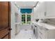 Well-appointed laundry room with ample counter space, modern appliances, and natural light from the window at 4345 Mount Paran Nw Pkwy, Atlanta, GA 30327