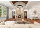 Elegant living room featuring a stone fireplace, decorative lighting, hardwood floors, and large windows offering ample natural light at 4345 Mount Paran Nw Pkwy, Atlanta, GA 30327