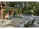 Outdoor patio area with seating, brick accents, and view of the pool and landscaped backyard at 4345 Mount Paran Nw Pkwy, Atlanta, GA 30327