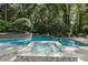 Beautiful pool and hot tub surrounded by lush landscaping and mature trees at 4345 Mount Paran Nw Pkwy, Atlanta, GA 30327