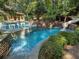 Backyard pool with slide and waterfall feature surrounded by lush landscaping at 4345 Mount Paran Nw Pkwy, Atlanta, GA 30327