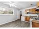 Eat-in kitchen with wood cabinets and vinyl flooring at 5904 Heatherwood Ln, Riverdale, GA 30296