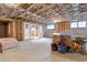 Unfinished basement with exposed beams and access to patio at 4851 Hanalei Holw, Suwanee, GA 30024