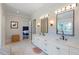 Double vanity bathroom with marble flooring and a view into a bedroom at 4851 Hanalei Holw, Suwanee, GA 30024