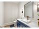 Modern powder room with a navy blue vanity and a sleek sink at 4851 Hanalei Holw, Suwanee, GA 30024