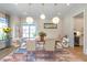 Formal dining room with hardwood floors, large windows, and modern light fixtures at 4851 Hanalei Holw, Suwanee, GA 30024