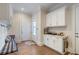 Functional entryway with built-in bench, cabinets, and storage at 4851 Hanalei Holw, Suwanee, GA 30024