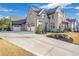 Front view of house showcasing three-car garage and landscaping at 4851 Hanalei Holw, Suwanee, GA 30024