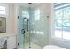 Large walk-in shower with marble tile and glass enclosure at 4851 Hanalei Holw, Suwanee, GA 30024