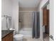 Clean bathroom with tiled shower and tub, granite countertop and modern toilet at 855 Peachtree Ne St # 1508, Atlanta, GA 30308