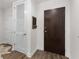 Hallway featuring hardwood floors, closet with louvered door, and dark wood front door at 855 Peachtree Ne St # 1508, Atlanta, GA 30308