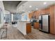 Open-concept kitchen with stainless steel appliances and hardwood flooring at 855 Peachtree Ne St # 1508, Atlanta, GA 30308