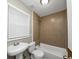 Tiled bathroom features a shower-tub combo and sink with modern fixtures at 1454 Westridge Sw Rd, Atlanta, GA 30311