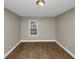 Bright bedroom with wood floors, neutral paint, and natural light from one window at 1454 Westridge Sw Rd, Atlanta, GA 30311