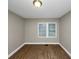 Well-lit bedroom with hardwood floors and window at 1454 Westridge Sw Rd, Atlanta, GA 30311