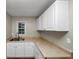 White cabinets and corner sink define this kitchen at 1454 Westridge Sw Rd, Atlanta, GA 30311