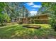 Spacious backyard with mature trees and a brick home exterior at 2144 Kennesaw Due West Nw Rd, Kennesaw, GA 30152
