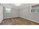 Finished basement room with wood-look flooring and natural light from two windows at 2144 Kennesaw Due West Nw Rd, Kennesaw, GA 30152
