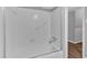 Bright white bathroom featuring a shower and bathtub with gray accents and flooring at 2144 Kennesaw Due West Nw Rd, Kennesaw, GA 30152