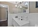 Bathroom with white tile, a large mirror, and classic pendant lighting at 2144 Kennesaw Due West Nw Rd, Kennesaw, GA 30152