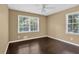 Bright bedroom with hardwood floors and views of surrounding greenery through multiple windows at 2144 Kennesaw Due West Nw Rd, Kennesaw, GA 30152