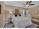 Cozy bedroom featuring a ceiling fan and ample natural light from the nearby window at 2144 Kennesaw Due West Nw Rd, Kennesaw, GA 30152